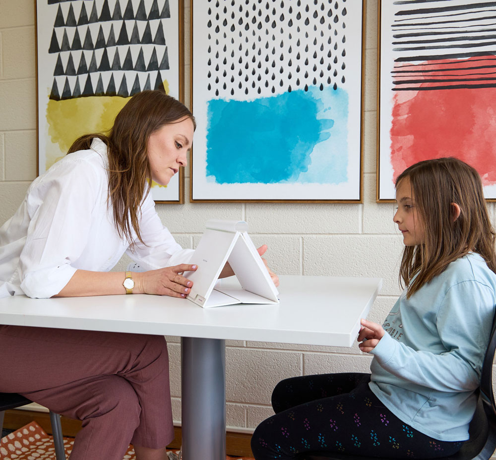 Bailey Majeski performs a learning evaluation with a young girl at the Learning Evaluation Center in Littleton, Colorado