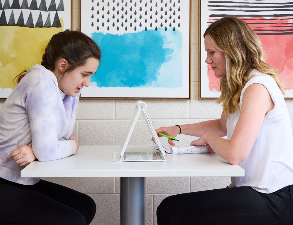 Dana Green performs a learning evaluation with a teen girl at the Learning Evaluation Center in Littleton, Colorado
